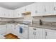 Updated kitchen with white cabinetry, stainless steel appliances, and a stylish backsplash at 2315 Fisher Dr, Loganville, GA 30052
