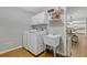 Functional laundry room with modern washer and dryer, storage cabinets, and a utility sink at 2315 Fisher Dr, Loganville, GA 30052