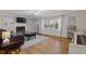 Spacious living room featuring a fireplace, hardwood floors, and large windows with views of nature at 2315 Fisher Dr, Loganville, GA 30052