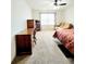 Spacious bedroom features plush carpeting, a ceiling fan, and ample natural light from the window at 6408 Kennonbriar Ct, Lithonia, GA 30058