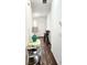 Inviting foyer featuring wood-look floors, a console table, and stairs to the upper level at 6408 Kennonbriar Ct, Lithonia, GA 30058