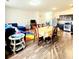 Open concept living and dining area features wood floors, stylish furnishings, and eat-in kitchen area at 6408 Kennonbriar Ct, Lithonia, GA 30058