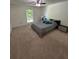Relaxing carpeted bedroom with large window, ceiling fan, and neutral tones at 6851 Roswell Rd # O10, Atlanta, GA 30328