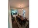 Cozy dining room featuring a chandelier, wood table set, and view of the living area at 6851 Roswell Rd # O10, Atlanta, GA 30328