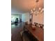 Open dining area featuring stylish lighting and seamless flow to living area with natural light at 6851 Roswell Rd # O10, Atlanta, GA 30328