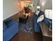 Comfortable living room with blue sofas, dark wood floors and view to dining room at 6851 Roswell Rd # O10, Atlanta, GA 30328