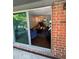 A peek inside, revealing a stylish living area and dining space from the outdoor patio at 6851 Roswell Rd # O10, Atlanta, GA 30328