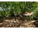 Lush backyard with multiple stone steps leads to a fire pit and the main house above at 2015 N Decatur Ne Rd, Atlanta, GA 30307