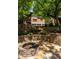 Backyard with a stone fire pit, lush landscaping and multi-level stone steps leading to the main house at 2015 N Decatur Ne Rd, Atlanta, GA 30307