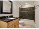 Bathroom with granite countertop sink, and shower-bathtub with dark brown tile and trim at 2015 N Decatur Ne Rd, Atlanta, GA 30307