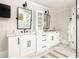 Bright bathroom features double sinks, white cabinetry, marble counters and tiled floors at 2015 N Decatur Ne Rd, Atlanta, GA 30307