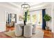 Formal dining room featuring hardwood floors, white trim, modern lighting, and access to an adjacent room at 2015 N Decatur Ne Rd, Atlanta, GA 30307