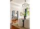 Formal dining room featuring hardwood floors, white trim, modern lighting, and an adjacent living room at 2015 N Decatur Ne Rd, Atlanta, GA 30307
