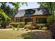 Charming brick home featuring a stone chimney, dormer and professionally landscaped front yard with a stone pathway at 2015 N Decatur Ne Rd, Atlanta, GA 30307