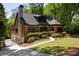 Charming brick home with stone accents, dormer, black framed windows, driveway gate and a professionally landscaped yard at 2015 N Decatur Ne Rd, Atlanta, GA 30307