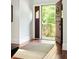 Bright foyer showcasing hardwood floors, traditional trim, and a glimpse of the verdant exterior at 2015 N Decatur Ne Rd, Atlanta, GA 30307
