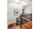 Upstairs hallway with wood floors, skylights, and wrought iron railing at 2015 N Decatur Ne Rd, Atlanta, GA 30307