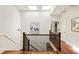 Upstairs hallway with wood floors, skylights, and wrought iron railing at 2015 N Decatur Ne Rd, Atlanta, GA 30307
