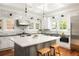 Open kitchen with marble backsplash, stainless steel appliances, and spacious island at 2015 N Decatur Ne Rd, Atlanta, GA 30307