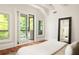 Main bedroom with wood floors and a door to a balcony at 2015 N Decatur Ne Rd, Atlanta, GA 30307