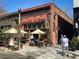 Cozy brick building with outdoor seating, featuring umbrellas and lush greenery at 2015 N Decatur Ne Rd, Atlanta, GA 30307