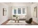 Cozy sitting area with couch, chair, and three windows at 2015 N Decatur Ne Rd, Atlanta, GA 30307