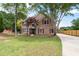 Beautiful brick home with a well-maintained lawn and a long driveway leading to the property at 5300 Coacoochee Ter, Johns Creek, GA 30022