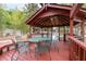 Interior view of a gazebo with a dining table set, offering a cozy outdoor dining space with a view of the pool at 5300 Coacoochee Ter, Johns Creek, GA 30022