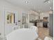 Spacious eat-in kitchen with white cabinets, stainless steel appliances, and access to back yard at 5300 Coacoochee Ter, Johns Creek, GA 30022