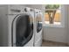 Laundry room features a washer, dryer, and a window at 5300 Coacoochee Ter, Johns Creek, GA 30022
