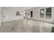 Bright living room featuring a marble floor and a view of the kitchen and backyard at 5300 Coacoochee Ter, Johns Creek, GA 30022