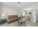 Bright living room featuring marble floors, a comfortable couch, and open access to the dining area at 5300 Coacoochee Ter, Johns Creek, GA 30022