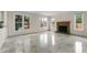 Bright living room featuring a green marble fireplace, marble flooring, and multiple windows at 5300 Coacoochee Ter, Johns Creek, GA 30022