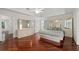 Spacious main bedroom boasts hardwood floors, tray ceiling, and mirrored dressing area at 5300 Coacoochee Ter, Johns Creek, GA 30022