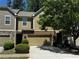 Charming townhome with a two-car garage and tasteful brick and siding accents at 1598 Lenox Overlook Ne Rd, Atlanta, GA 30329