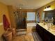 A full main bathroom with a glass enclosed shower and bath, a double sink vanity, large mirror, and tile flooring at 1598 Lenox Overlook Ne Rd, Atlanta, GA 30329