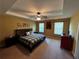 This main bedroom features a trey ceiling, a ceiling fan and light, carpet, and two large windows at 1598 Lenox Overlook Ne Rd, Atlanta, GA 30329