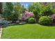 A view of the lush backyard garden with colorful blooms at 2648 Rivers Nw Rd, Atlanta, GA 30305