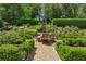 This outdoor entertaining area features a table and chairs surrounded by manicured landscaping at 2648 Rivers Nw Rd, Atlanta, GA 30305