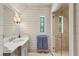 Bright bathroom featuring tiled shower, vanity, and horizontal shiplap detail at 2648 Rivers Nw Rd, Atlanta, GA 30305