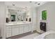 Bright bathroom features a double vanity with marble countertop and large mirror at 2648 Rivers Nw Rd, Atlanta, GA 30305