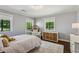Cozy bedroom features hardwood floors, a fluffy rug, and sunny windows at 2648 Rivers Nw Rd, Atlanta, GA 30305