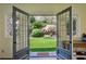 Open doors provide an inviting view to the lush landscaped backyard at 2648 Rivers Nw Rd, Atlanta, GA 30305