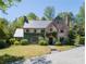 Charming brick two-story home with a well-manicured lawn and lush landscaping at 2648 Rivers Nw Rd, Atlanta, GA 30305