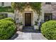Inviting entryway with stone accents, lush greenery, and a classic wood door at 2648 Rivers Nw Rd, Atlanta, GA 30305