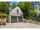 Detached two-car garage with gray doors and brick accents at 2648 Rivers Nw Rd, Atlanta, GA 30305