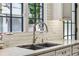 Close-up of a kitchen sink with a modern faucet and marble countertops at 2648 Rivers Nw Rd, Atlanta, GA 30305