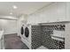 Modern laundry room features a sink, laundry machines, and ample cabinets at 2648 Rivers Nw Rd, Atlanta, GA 30305