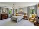 Spacious main bedroom with a chandelier, soft colors, and large windows at 2648 Rivers Nw Rd, Atlanta, GA 30305