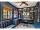 Inviting blue office featuring built-in shelves, a comfortable leather couch, and lots of light at 2648 Rivers Nw Rd, Atlanta, GA 30305